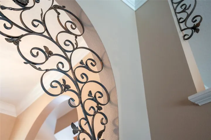 The ceilings and archways are all highlighted by crown molding & custom wrought iron lattie motifs.