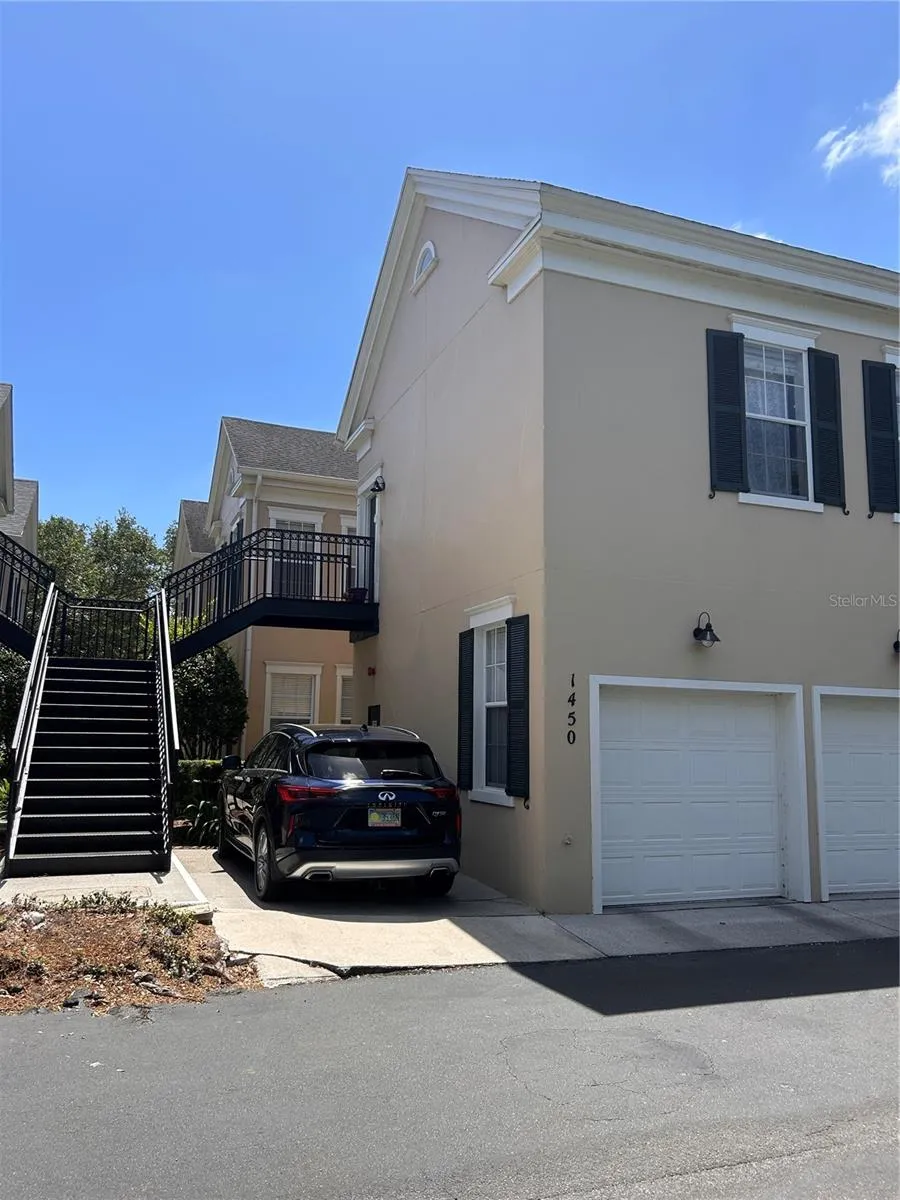 Stairs leading to the home.  Car parked in the space - that is the reserved parking space for this property.