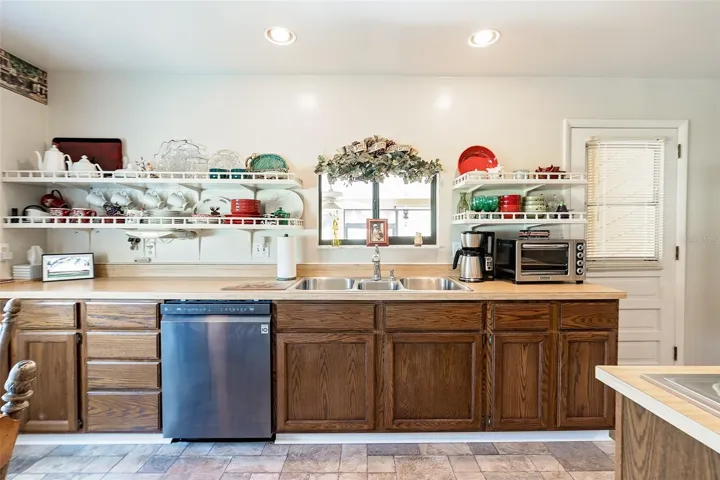 Beautiful View form your kitchen window. Very well maintained Oak wood cabinetry with Butcher block look tops and Decorative Open shelving for storage.