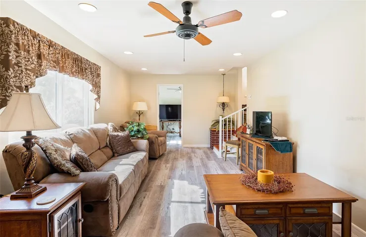 Generously sized Family room is located just down a couple of steps off of the formal dining area.  Has room for the WHOLE FAMILY and friends!!