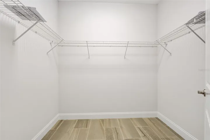 Primary bedroom walk-in closet