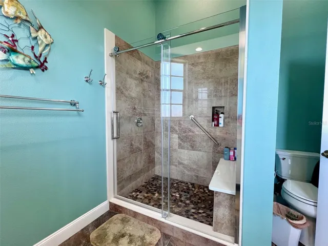 New shower with bench seating and glass doors