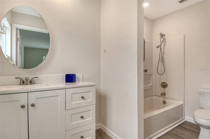 Updated ensuite bath with stone-topped vanity