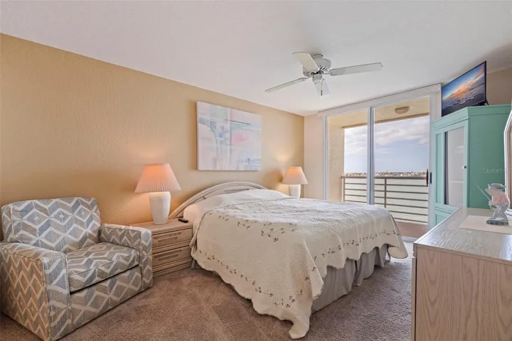 Primary bedroom with private waterfront balcony.