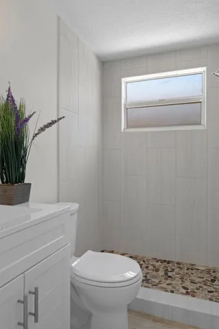 Full Bathroom near garage door and kitchen.  Check out this mirror - it lights just by touching the button on the mirror.