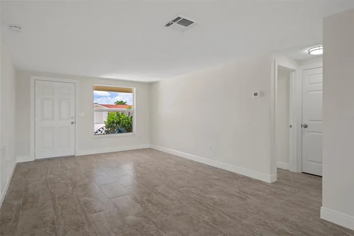 View of the Florida Room and to the right is the kitchen area with dining area.   You can also add a Dining area with the Living Room .  Large space.