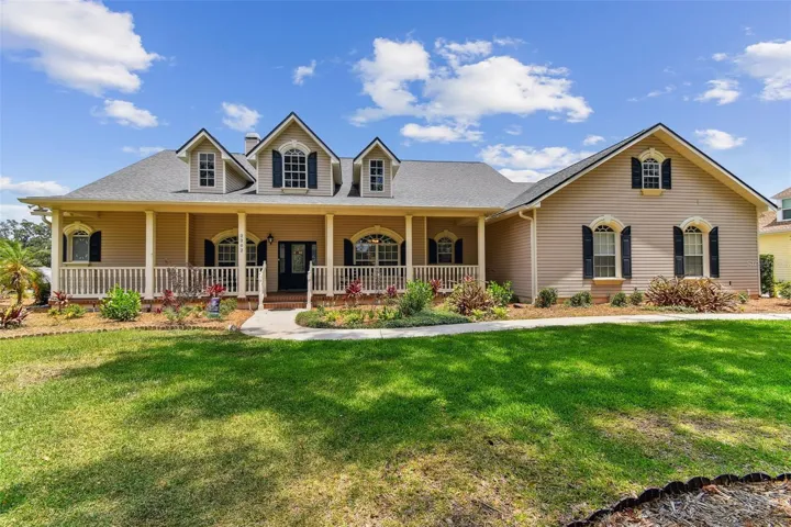 Front exterior view of 2202 Colewood Ln in Dover, Florida – with well maintained landscaping.