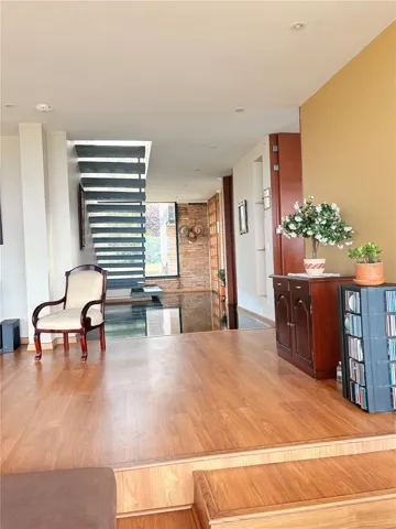 Looking back from Living room to foyer and floating stairs to second level