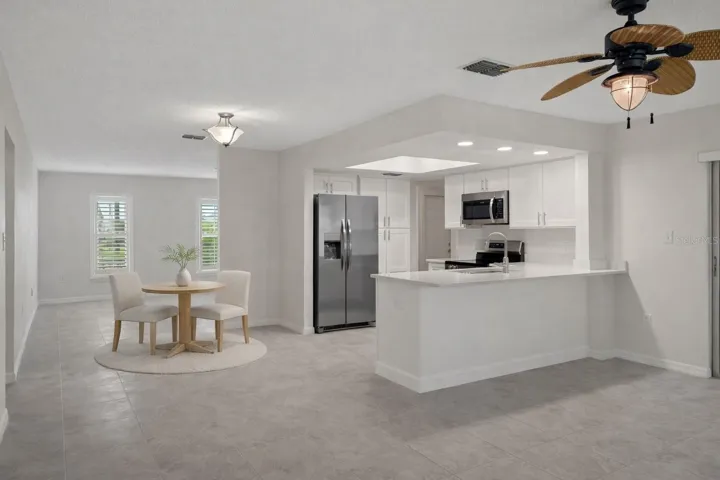 Casual dining space positioned for easy flow and functionality. (virtual staged)