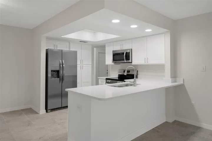 Granite countertops and stainless appliances complete the space.