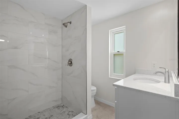 Updated bathroom with modern fixtures and finishes.
