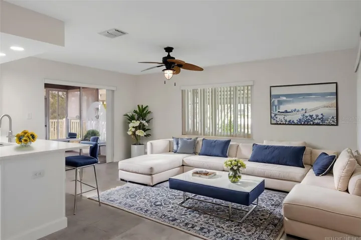 Light-filled living area with a relaxed coastal feel. (virtual staged)