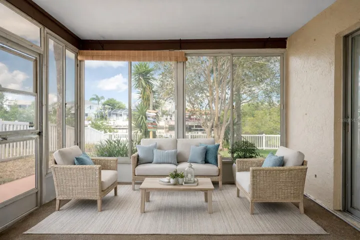 Screened lanai ideal for enjoying the breeze and canal views. (staged)