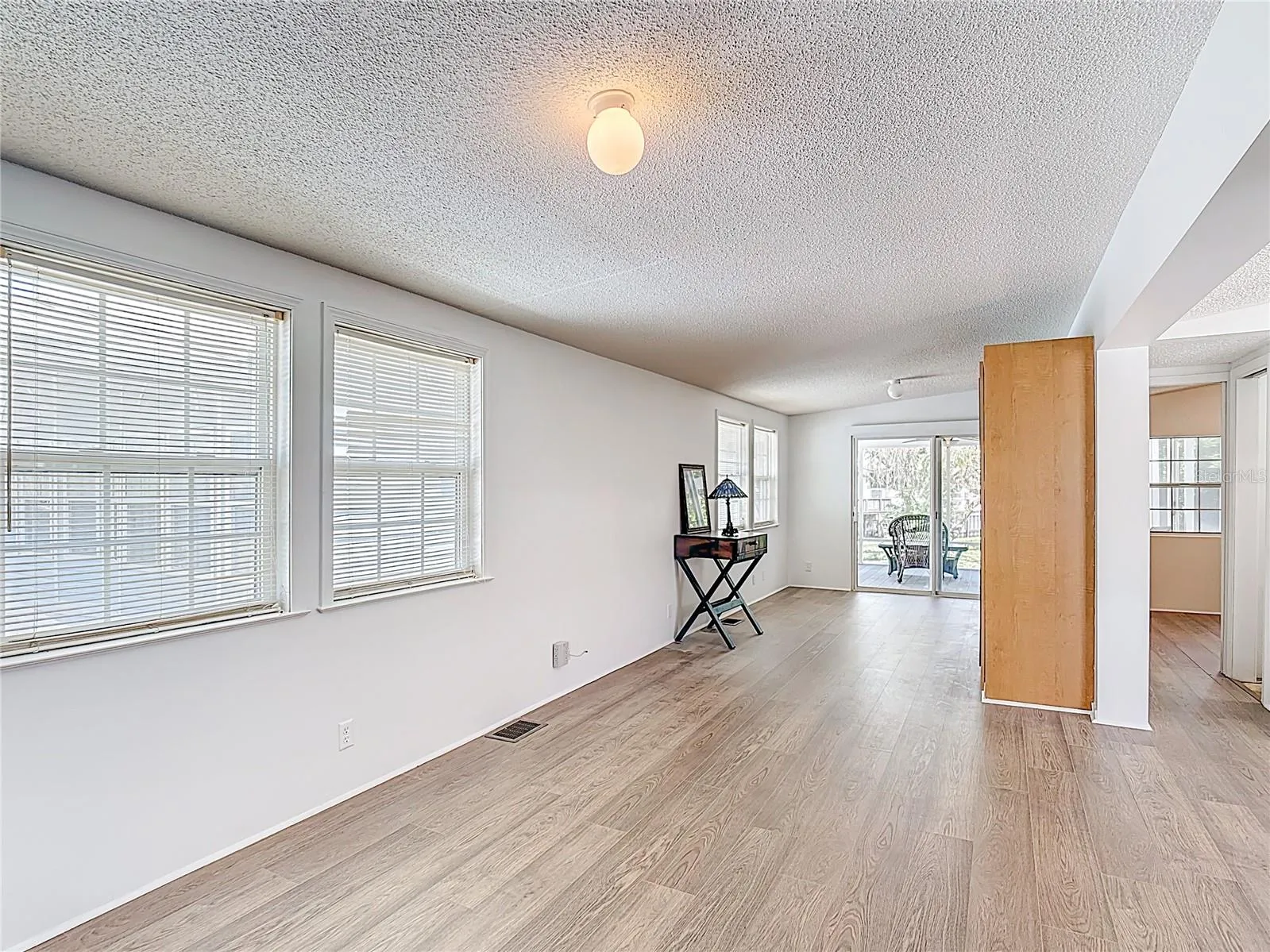Natural light pours through the abundance of windows and siding glass doors