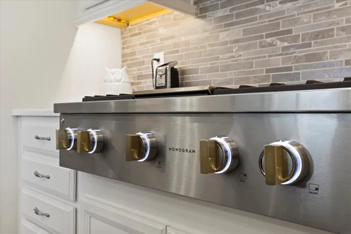 Monogram deluxe gas stove with warmer light and enhanced knob light features