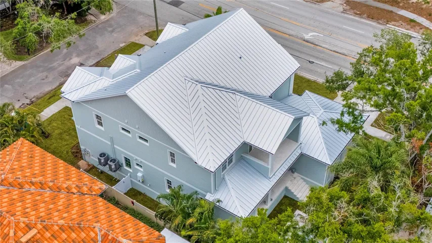 Standing seam metal roof and elevated construction highlight the quality and durability of this custom build.