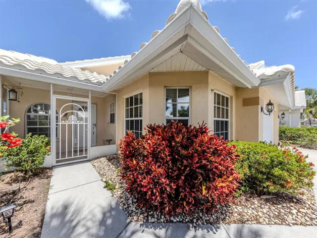 The home's front entrance is professionally landscaped and includes a screened in front porch.