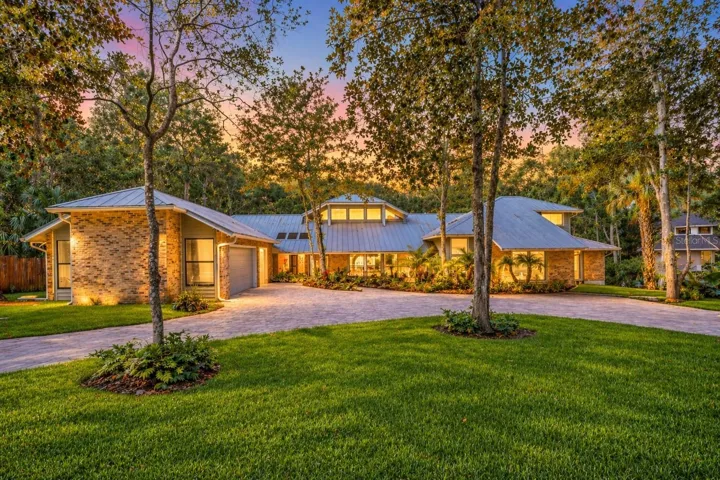 Tucked away at the end of a quiet CUL-DE-SAC in the desirable Trails community of Ormond Beach, this extraordinary CUSTOM WATERFRONT ESTATE sits on 1.31 ACRES surrounded by mature trees with a SCREENED POOL/SPA and PRIVATE DOCK on the TOMOKA RIVER, offering unmatched privacy in a tranquil setting!