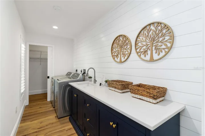 Laundry room with extra storage and walk-in closet.