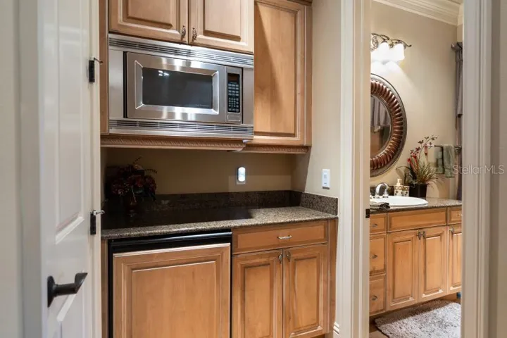 Kitchenette set up with microwave and small refrigerator