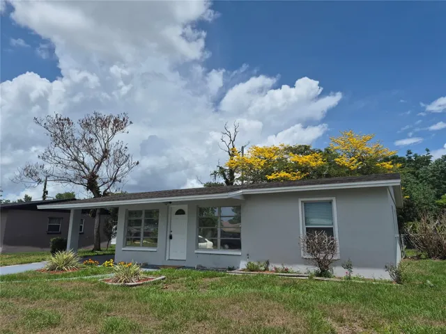Home exterior featuring the backyard tree in bloom