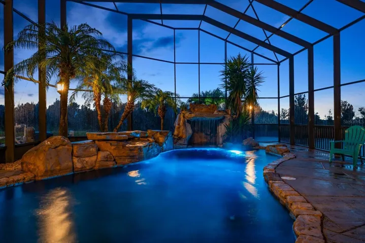 Breathtaking pool with grotto waterfall and endless view that flows seamlessly into the outdoor boating areas.