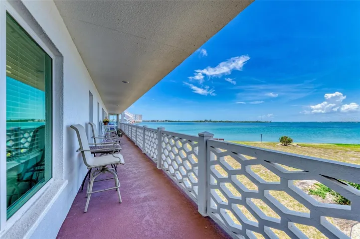 Covered walkway and balcony for unit entry with water view of Sarasota Bay