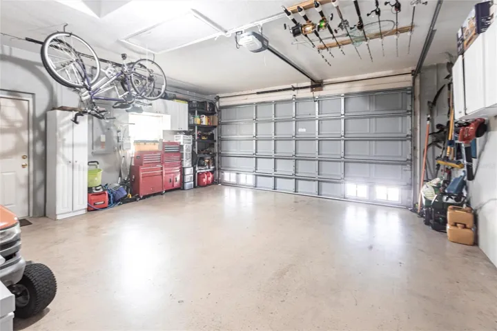 Large garage with room for vehicles, storage, and hobby space.