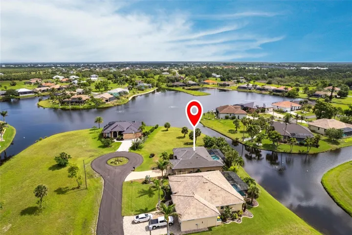 Stunning aerial perspective featuring the home’s lakefront position and tranquil water vistas