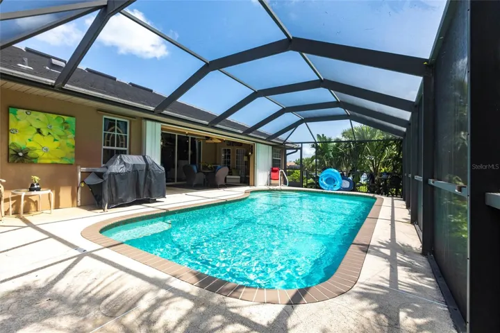 Inviting screened pool area with relaxing water views and tropical surroundings.
