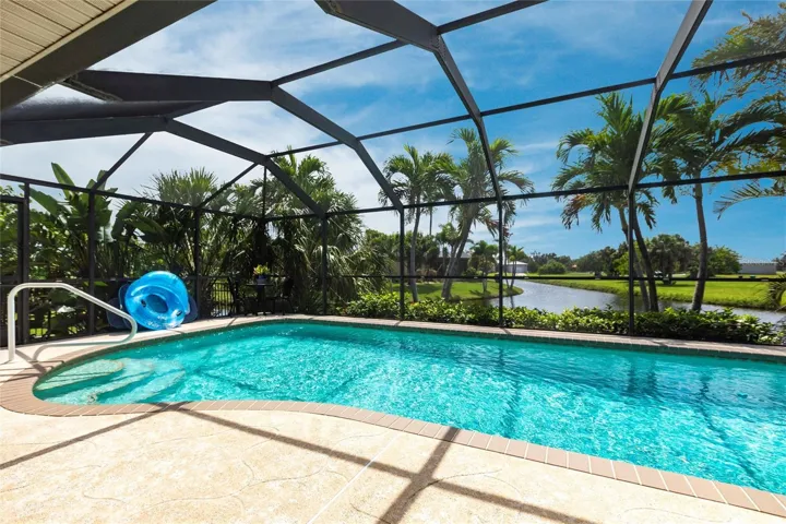 Inviting screened pool area with relaxing water views and tropical surroundings.
