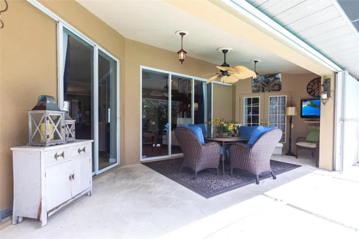Beautiful outdoor living space with covered lanai and dining area.