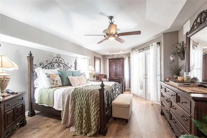 The oversized owners bedroom has seating space and French door pool access