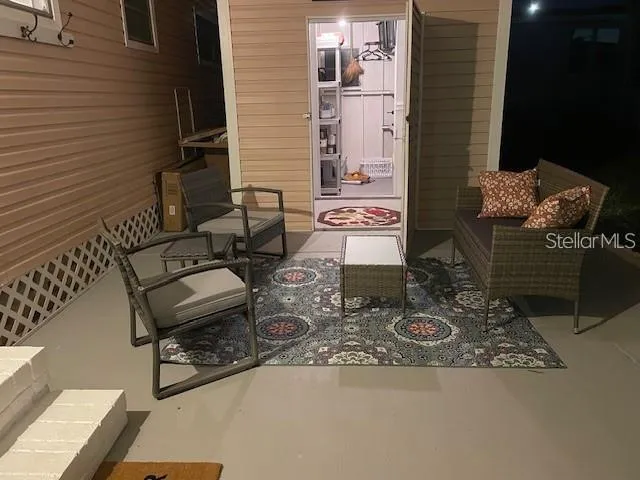 Patio/carport set up before sellers went home (north). Furniture and rug stored in front room.