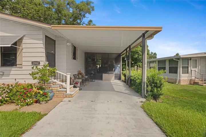 Wide carport, additional screened patio behind
