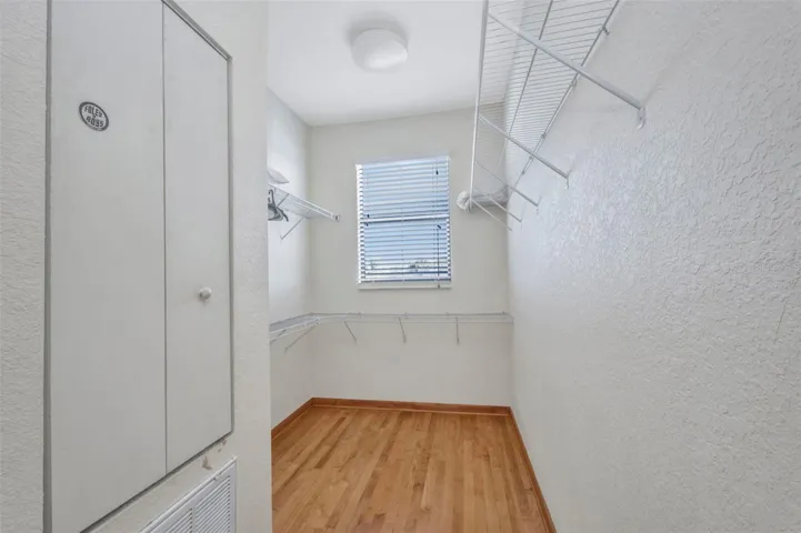 Primary bedroom walk-in closet
