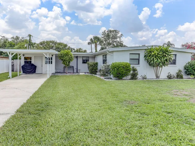 Front of the home with a one car carport.