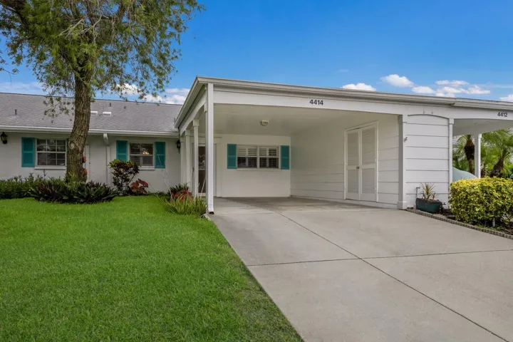 Front entrance with extra wide carport and storage