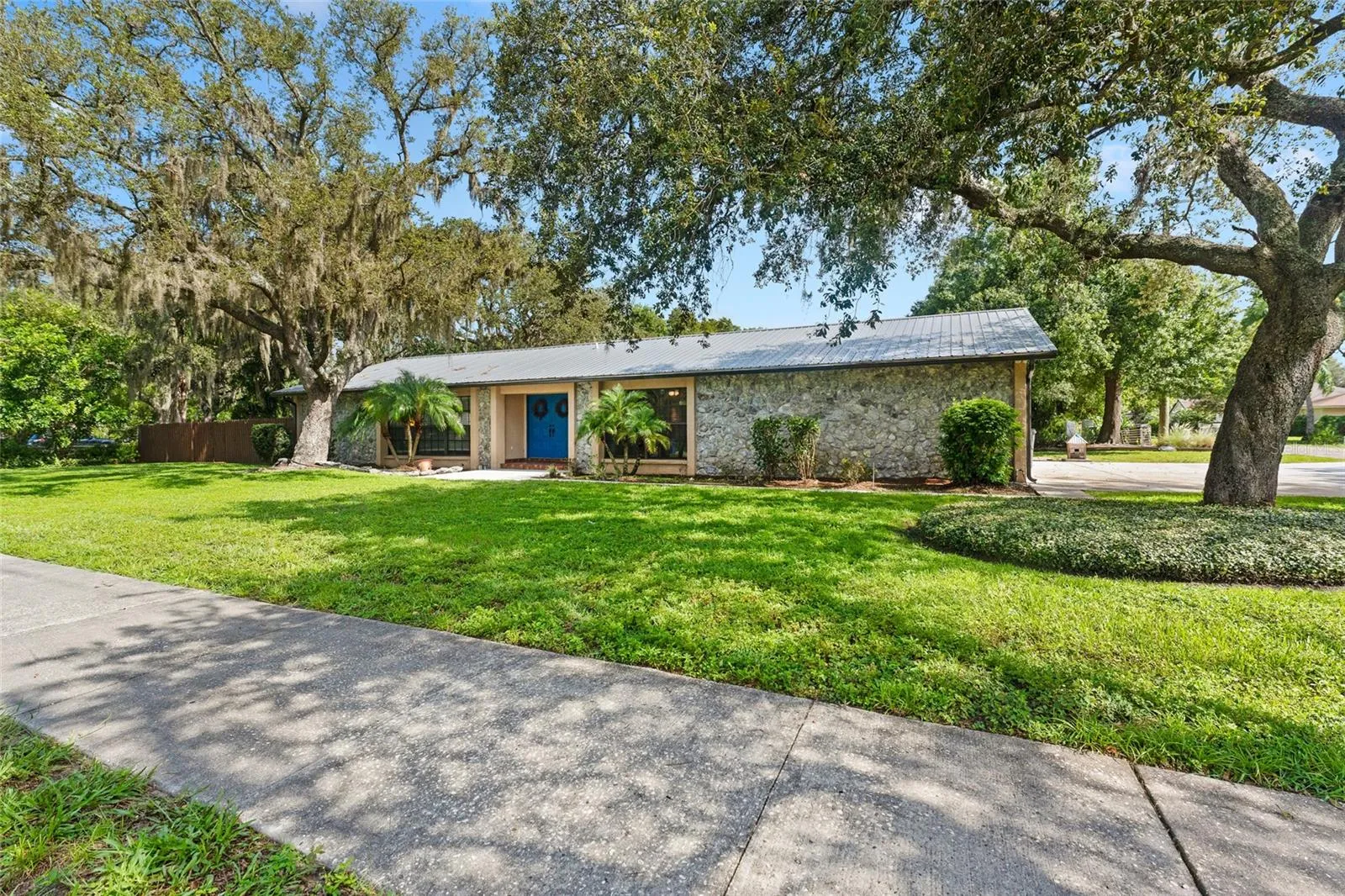 Fully Renovated Kitchen is a true centerpiece, featuring crisp white cabinetry, granite countertops, a massive center island, stainless steel appliances, and designer lighting.