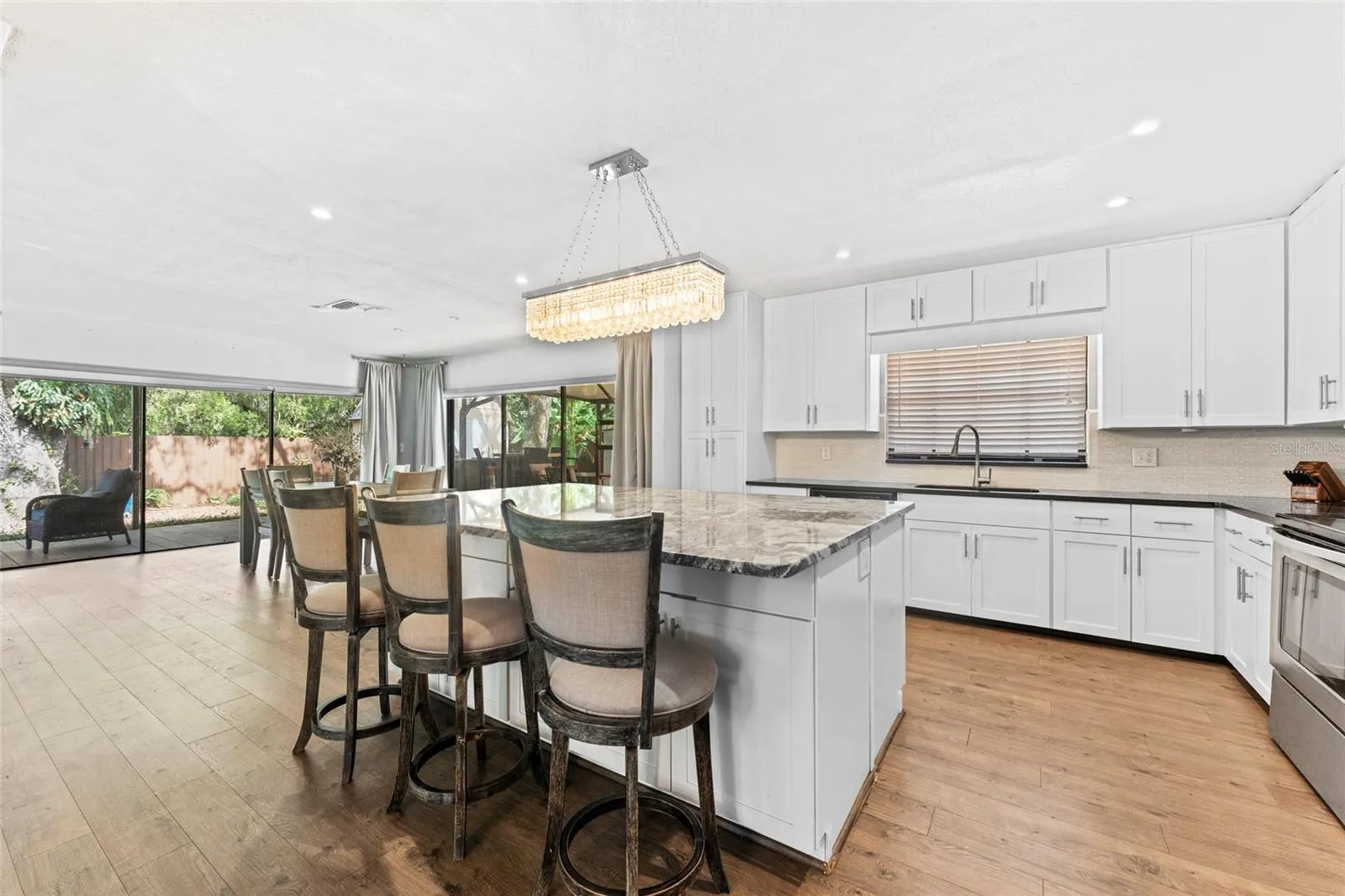 Expansive sliding glass doors fill the living and dining areas with natural light.