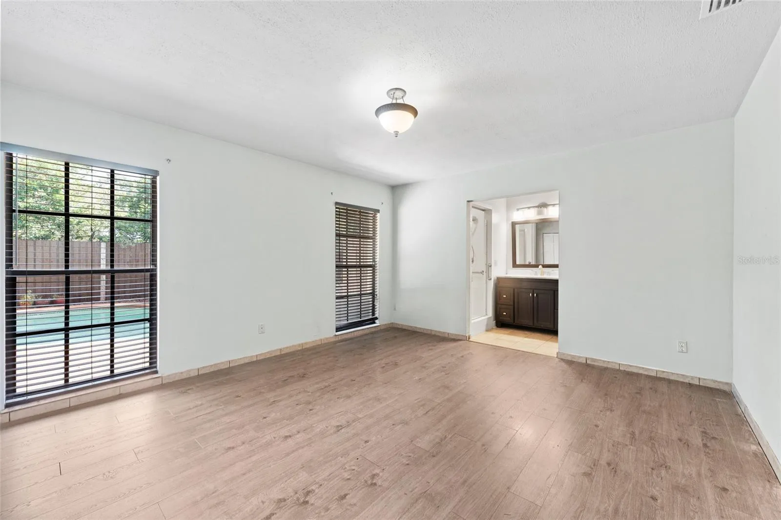 Primary Bedroom is 13' x 15', with laminate flooring, dual closets, and a ceiling fan.