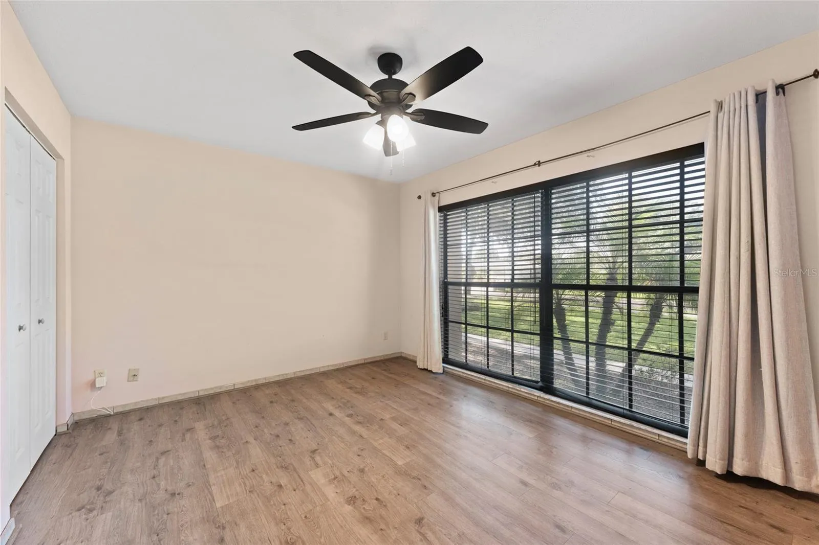 Bedroom 2 is 13' x 10.9', with laminate flooring, dual closets, and a ceiling fan.
