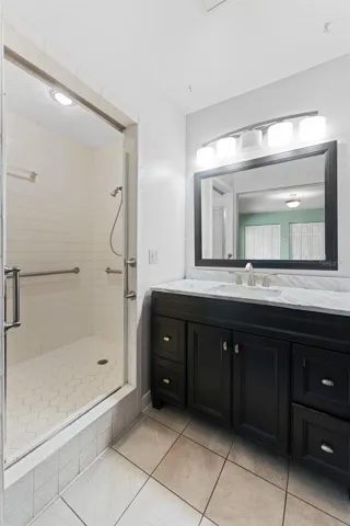 Primary Bedroom features an en suite bathroom, with vanity, separate toilet area, and glass-enclosed shower.