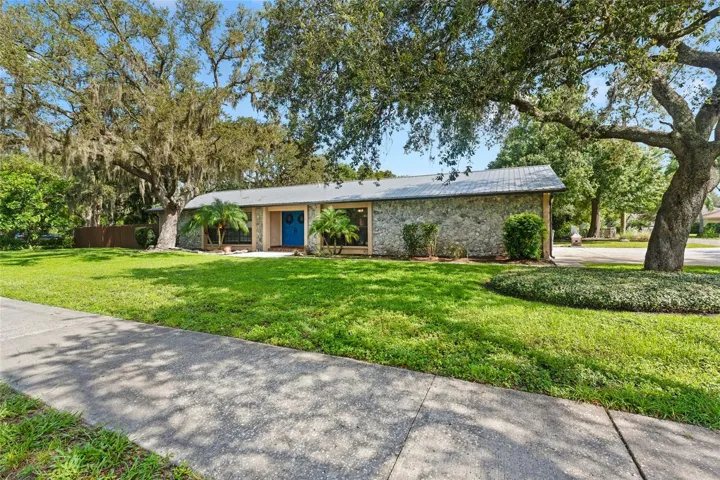 Fully Renovated Kitchen is a true centerpiece, featuring crisp white cabinetry, granite countertops, a massive center island, stainless steel appliances, and designer lighting.