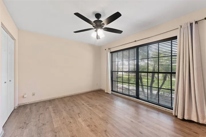 Bedroom 2 is 13' x 10.9', with laminate flooring, dual closets, and a ceiling fan.