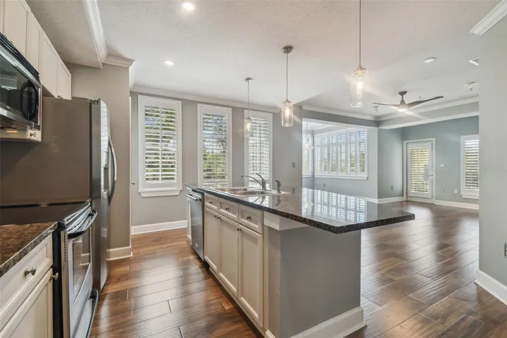 View of open floor plan combining kitchen, dining and living rooms.