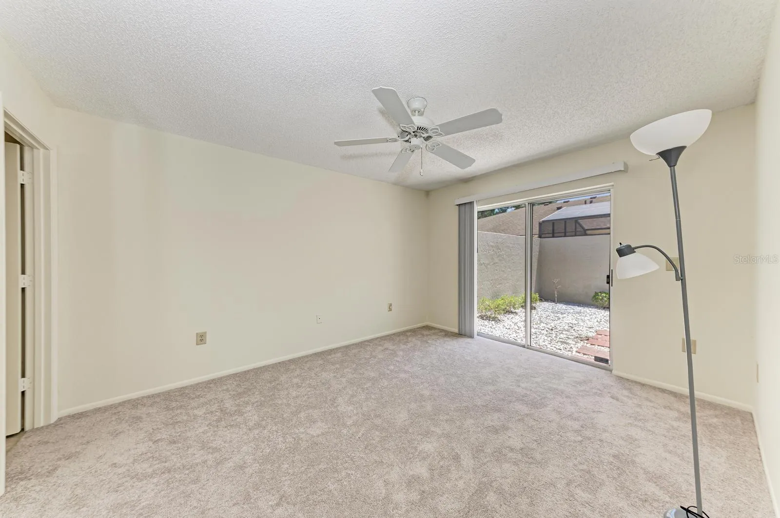 Master bedroom with patio in background