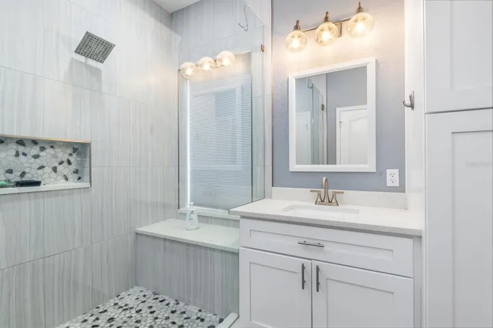 Designer lighting and mirrors in bathroom.