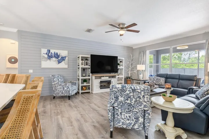 Family room has shiplap accent wall and soft grey paint.