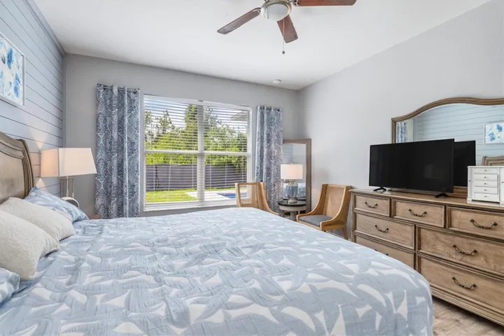 Window from primary bedroom overlooks pool and back yard.